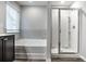 Modern bathroom showcasing a tub and tiled walls adjacent to a glass-enclosed shower at 1908 Stanton Rd, East Point, GA 30344