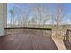 Wide deck offers a serene outdoor space with views of the surrounding trees and neighborhood at 70 Wentworth Ln, Villa Rica, GA 30180