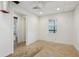 Unfinished basement with concrete floor, drop ceiling and bright lights with a single window at 70 Wentworth Ln, Villa Rica, GA 30180