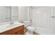 Bathroom with tub and shower featuring a single sink vanity and neutral tile at 70 Wentworth Ln, Villa Rica, GA 30180
