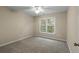 Carpeted bedroom featuring neutral walls, a ceiling fan, a window, and base molding at 70 Wentworth Ln, Villa Rica, GA 30180