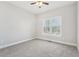 Bedroom with neutral walls and carpeting, featuring double windows and ceiling fan at 70 Wentworth Ln, Villa Rica, GA 30180