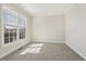 Neutral bedroom with carpet flooring, crown molding, a window, and plenty of natural light at 70 Wentworth Ln, Villa Rica, GA 30180