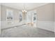 Elegant dining room with chandelier and windows, leading to the front entry at 70 Wentworth Ln, Villa Rica, GA 30180