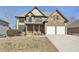 Charming two-story home with a stone and yellow siding exterior and a two-car garage at 70 Wentworth Ln, Villa Rica, GA 30180