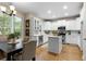 Bright kitchen featuring stainless appliances, island, white cabinets, and an adjacent breakfast nook at 70 Wentworth Ln, Villa Rica, GA 30180