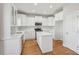 Beautiful kitchen featuring white cabinets, stainless steel appliances, a center island, and hardwood floors at 70 Wentworth Ln, Villa Rica, GA 30180