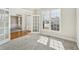 Bright living room with large windows and neutral tones, enhanced by natural light and French doors at 70 Wentworth Ln, Villa Rica, GA 30180
