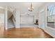 Open concept living room and foyer featuring hardwood floors, carpet, a fireplace, staircase, and exterior access at 70 Wentworth Ln, Villa Rica, GA 30180