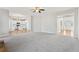 Open-concept living room with a fireplace, plush carpeting, and access to the kitchen at 70 Wentworth Ln, Villa Rica, GA 30180
