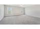 Spacious main bedroom with neutral walls, large windows, and plush carpeting at 70 Wentworth Ln, Villa Rica, GA 30180