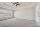Spacious main bedroom with a tray ceiling, carpet, and large windows at 70 Wentworth Ln, Villa Rica, GA 30180