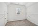 Walk-in closet with carpet flooring, one window, and white closet system at 70 Wentworth Ln, Villa Rica, GA 30180