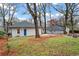 Spacious backyard showing an expansive lawn and mature trees, ideal for outdoor enjoyment at 942 Byron Sw Dr, Atlanta, GA 30310