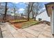 Backyard showcasing a large patio, greenery, and a tranquil outdoor setting at 942 Byron Sw Dr, Atlanta, GA 30310