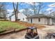 Large backyard features a fire pit and mature trees, creating a relaxing retreat at 942 Byron Sw Dr, Atlanta, GA 30310