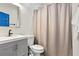 This bathroom features a bright blue door and a shower/tub combo with a tan shower curtain at 942 Byron Sw Dr, Atlanta, GA 30310