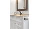 Bathroom with a granite sink and a dark faucet, cabinet and mirror at 942 Byron Sw Dr, Atlanta, GA 30310