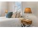 Bedroom window with bright natural light and staging with a pillow, blanket, and lamp at 942 Byron Sw Dr, Atlanta, GA 30310
