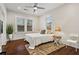 A bedroom with hardwood floors, a neutral color palette, two windows, and modern décor at 942 Byron Sw Dr, Atlanta, GA 30310
