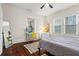 Bright bedroom with hardwood floors, modern desk area, and natural light from two windows at 942 Byron Sw Dr, Atlanta, GA 30310