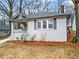 Charming home with a covered porch, manicured landscaping, and painted brick exterior at 942 Byron Sw Dr, Atlanta, GA 30310