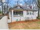Inviting home with a covered porch, manicured landscaping, and well-maintained front yard at 942 Byron Sw Dr, Atlanta, GA 30310