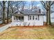 Charming bungalow featuring a covered front porch, painted brick facade, and well-maintained landscaping at 942 Byron Sw Dr, Atlanta, GA 30310