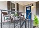 Inviting front porch features seating, plants, and a bright blue door for a welcoming entrance at 942 Byron Sw Dr, Atlanta, GA 30310