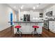 Open kitchen layout with a spacious island, bar stools, and modern appliances at 942 Byron Sw Dr, Atlanta, GA 30310