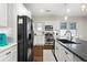 Open kitchen features white cabinets, stainless steel appliances, stone countertops, and hardwood flooring at 942 Byron Sw Dr, Atlanta, GA 30310