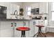Modern kitchen with white cabinets, stainless steel appliances, and bar stools at 942 Byron Sw Dr, Atlanta, GA 30310