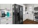Updated kitchen showcases white cabinetry, stainless steel appliances, and hardwood floors at 942 Byron Sw Dr, Atlanta, GA 30310