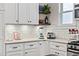 Stylish kitchen with white cabinets, subway tile, and modern countertop appliances at 942 Byron Sw Dr, Atlanta, GA 30310