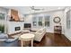 Cozy living room with hardwood floors, brick fireplace, and comfortable seating basks in natural light at 942 Byron Sw Dr, Atlanta, GA 30310