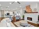 Open-concept living room featuring a fireplace, hardwood floors, and natural light at 942 Byron Sw Dr, Atlanta, GA 30310