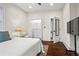 Bright main bedroom featuring a walk-in closet, sleek TV, and neutral decor at 942 Byron Sw Dr, Atlanta, GA 30310