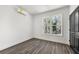 Bright bedroom with gray wood floors, white walls, and black door at 1106A Wedgewood Nw Dr, Atlanta, GA 30318