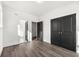 Bedroom with gray wood floors, white walls, and black closet doors at 1106A Wedgewood Nw Dr, Atlanta, GA 30318