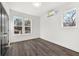 Bedroom with gray wood floors, white walls, and natural light from the large windows at 1106A Wedgewood Nw Dr, Atlanta, GA 30318