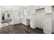 Modern kitchen with white cabinets, quartz countertops, stainless steel sink, and sleek wood flooring at 1106A Wedgewood Nw Dr, Atlanta, GA 30318