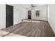 Bright living room with gray wood floors, white walls, and black door at 1106A Wedgewood Nw Dr, Atlanta, GA 30318