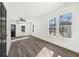 Bright living room with gray wood floors, white walls, and natural light from the large windows at 1106A Wedgewood Nw Dr, Atlanta, GA 30318