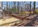 View of the backyard with a wooden deck, sunroom, and wooded scenery at 1628 Links Overlook, Stone Mountain, GA 30088