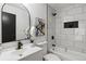 Modern bathroom features stylish white tile, black hardware and fixtures, and tasteful décor at 1628 Links Overlook, Stone Mountain, GA 30088