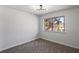 Bedroom features modern lighting fixture and a window providing natural light at 1628 Links Overlook, Stone Mountain, GA 30088
