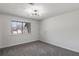 This bedroom has gray carpeting and a window offering natural light at 1628 Links Overlook, Stone Mountain, GA 30088