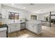 Open kitchen view to a fireplace and living area with an adjacent sunroom. Featuring modern quartz countertops and appliances at 1628 Links Overlook, Stone Mountain, GA 30088