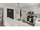 A kitchen featuring quartz countertops, stainless steel appliances, and a view into the dining room at 1628 Links Overlook, Stone Mountain, GA 30088