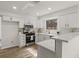 Bright kitchen featuring quartz countertops, modern stainless steel appliances, white cabinets, and subway tile backsplash at 1628 Links Overlook, Stone Mountain, GA 30088